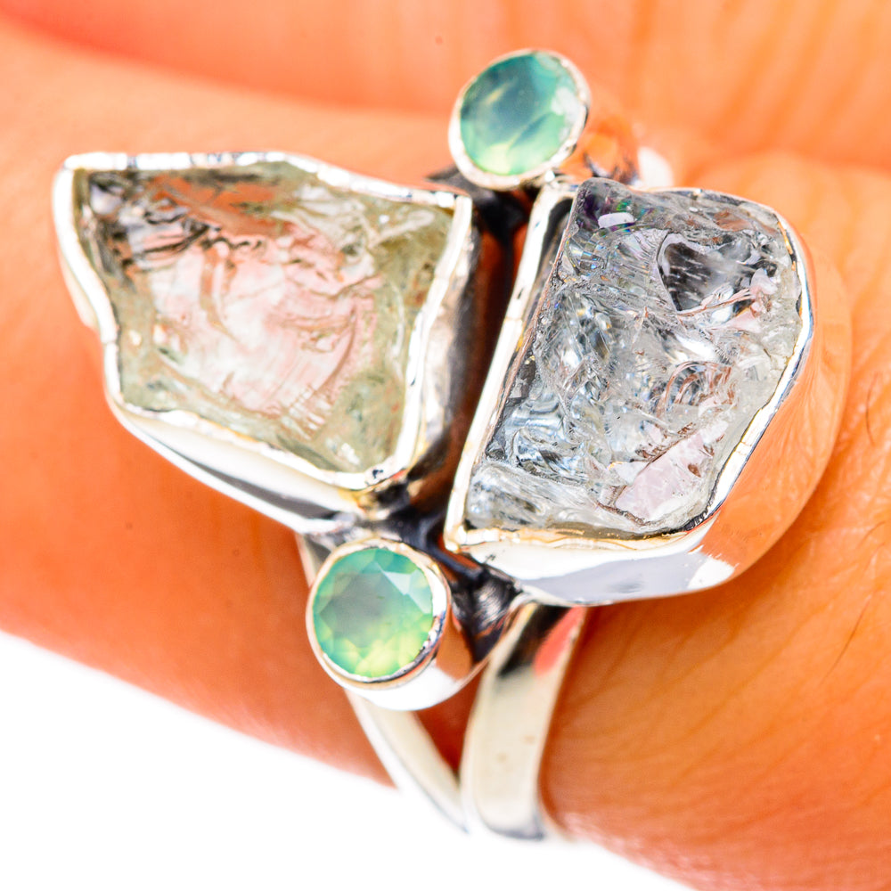 Rough aquamarine chalcedony ring with polished silver prongs and two green round accents