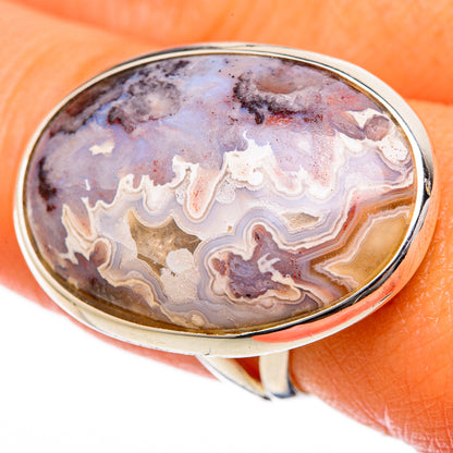 Large oval lace agate ring, close-up on oval stone with silver frame, purple-gray and cream