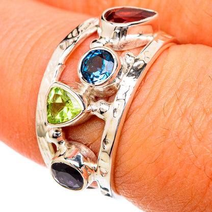 Sterling silver gemstone ring with blue round, green teardrop, red top, and dark bottom