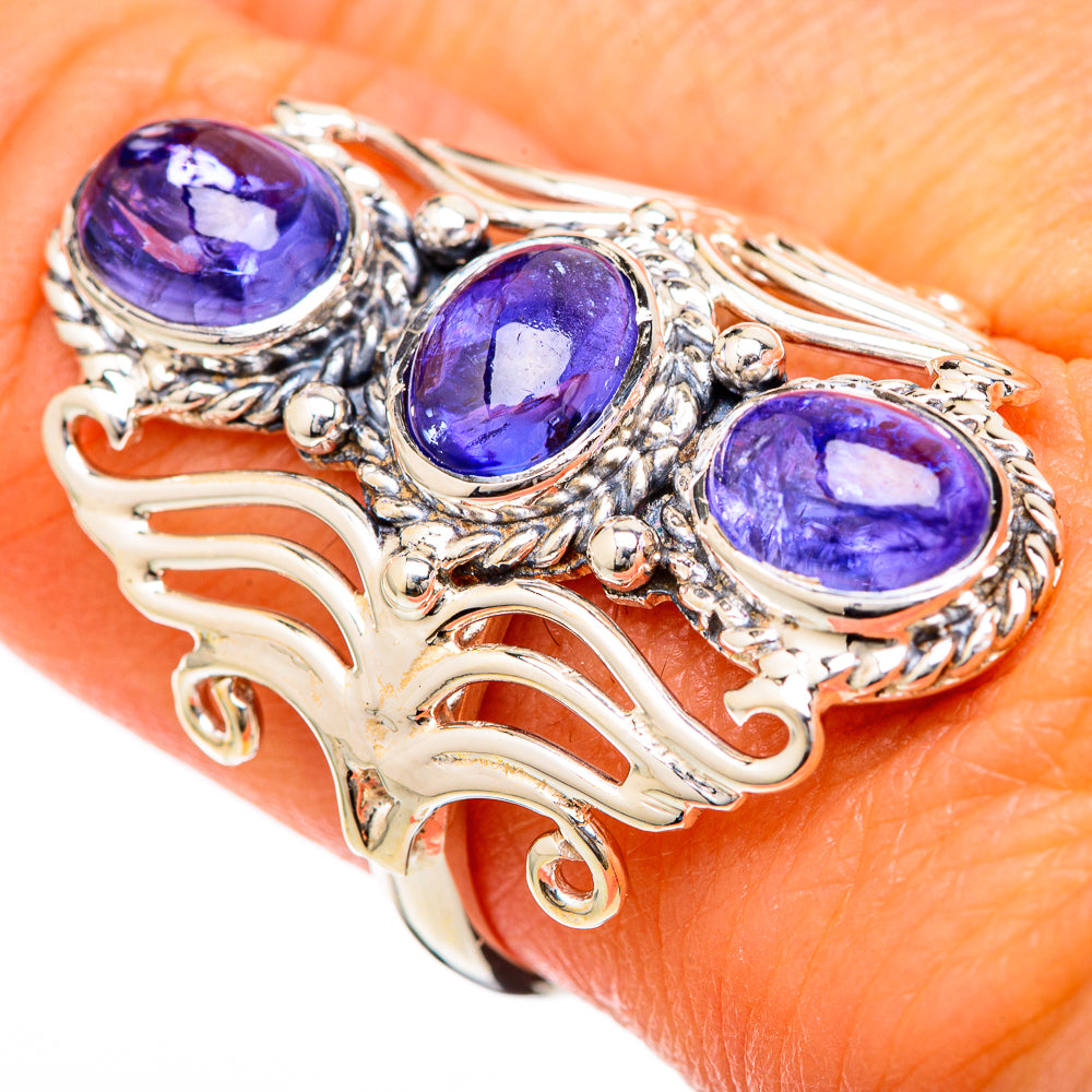Oval blue tanzanite gemstone ring with three stones on silver openwork band