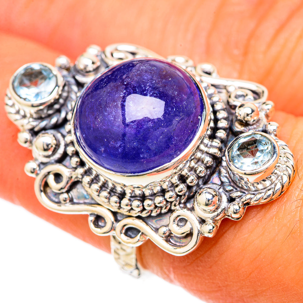 Sterling silver ring with large oval purple gemstone, set with small blue stones