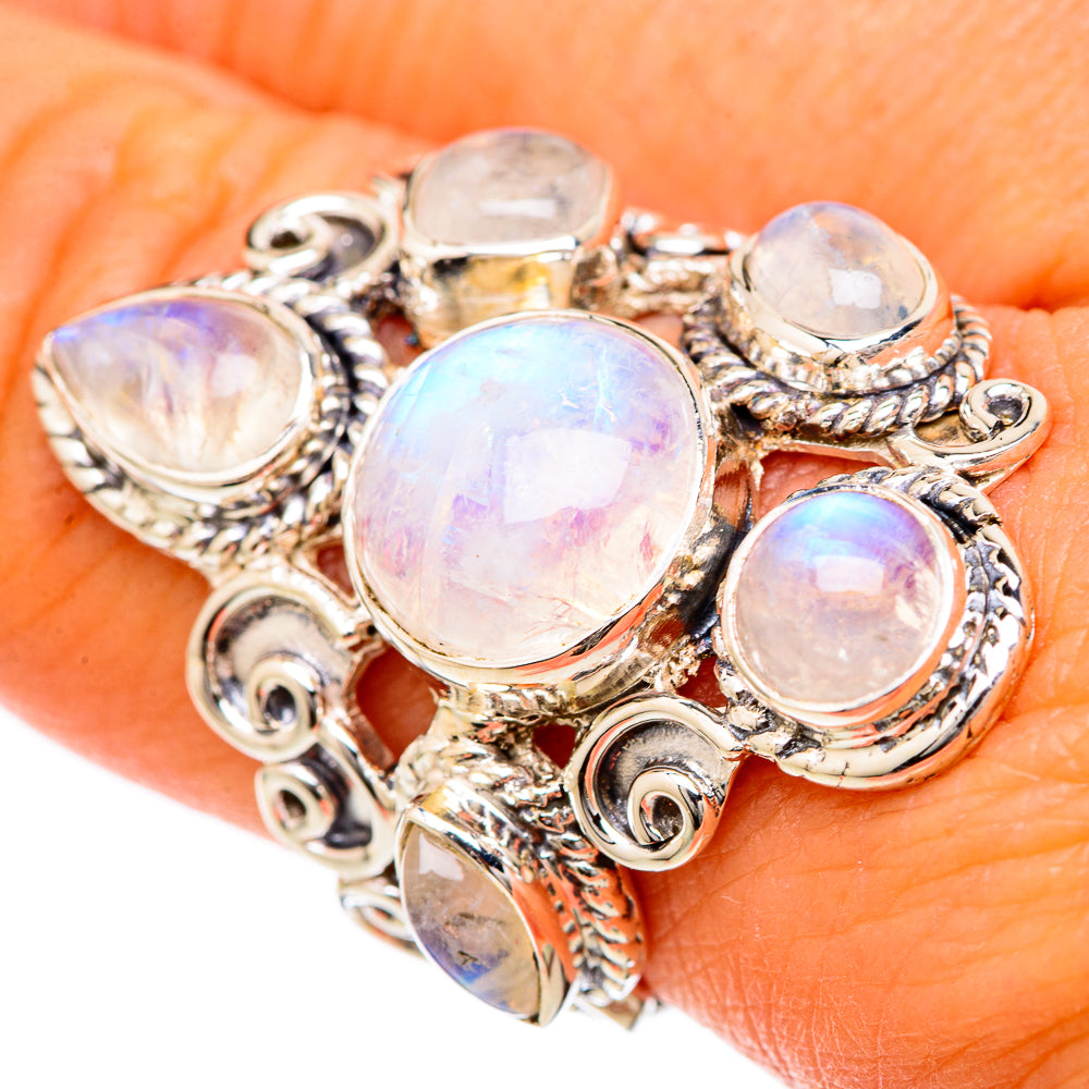 Silver moonstone ring with five oval rainbow cabochons in ornate swirl settings