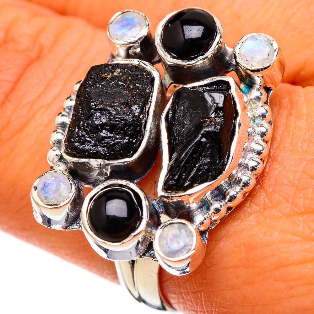 Sterling silver ring with large black cabochon and pale iridescent moonstone accents