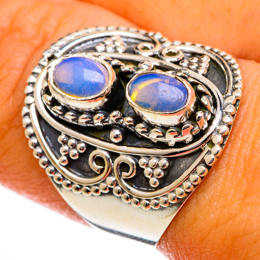 Sterling silver opal ring with two oval blue stones and ornate filigree settings