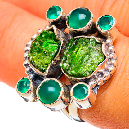 Sterling silver ring with rough green stone centerpiece and round green bezel-set gems