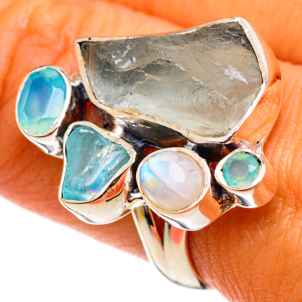 Sterling silver gemstone ring with moonstone cabochon, teal stones, and rough aquamarine