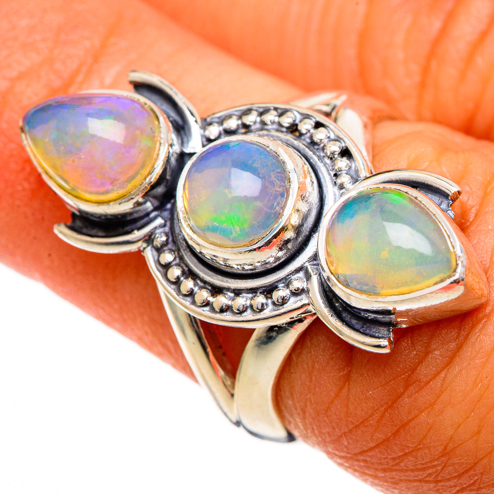 Sterling silver opal ring with three bezel-set multicolor cabochons and bead trim