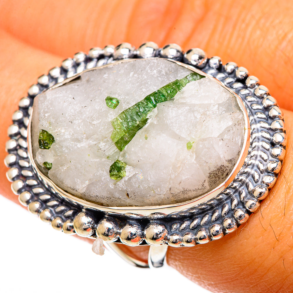 Quartz tourmaline ring on finger, oval bezel set in sterling silver