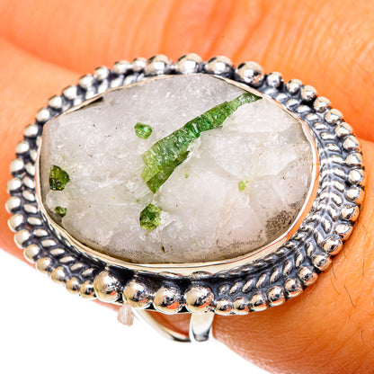 Quartz tourmaline ring on finger, oval bezel set in sterling silver