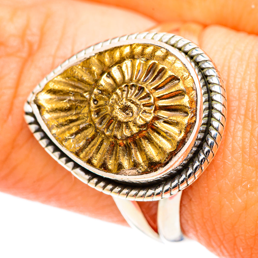 Silver oval pyrite fossil ring with gold-toned ammonite center and rope-style bezel