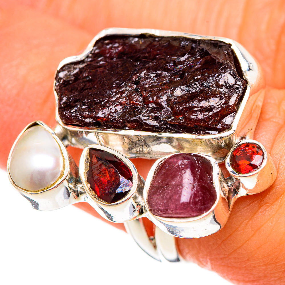 Sterling silver ring featuring rough dark red garnet, cultured pearl, and red gemstone studs