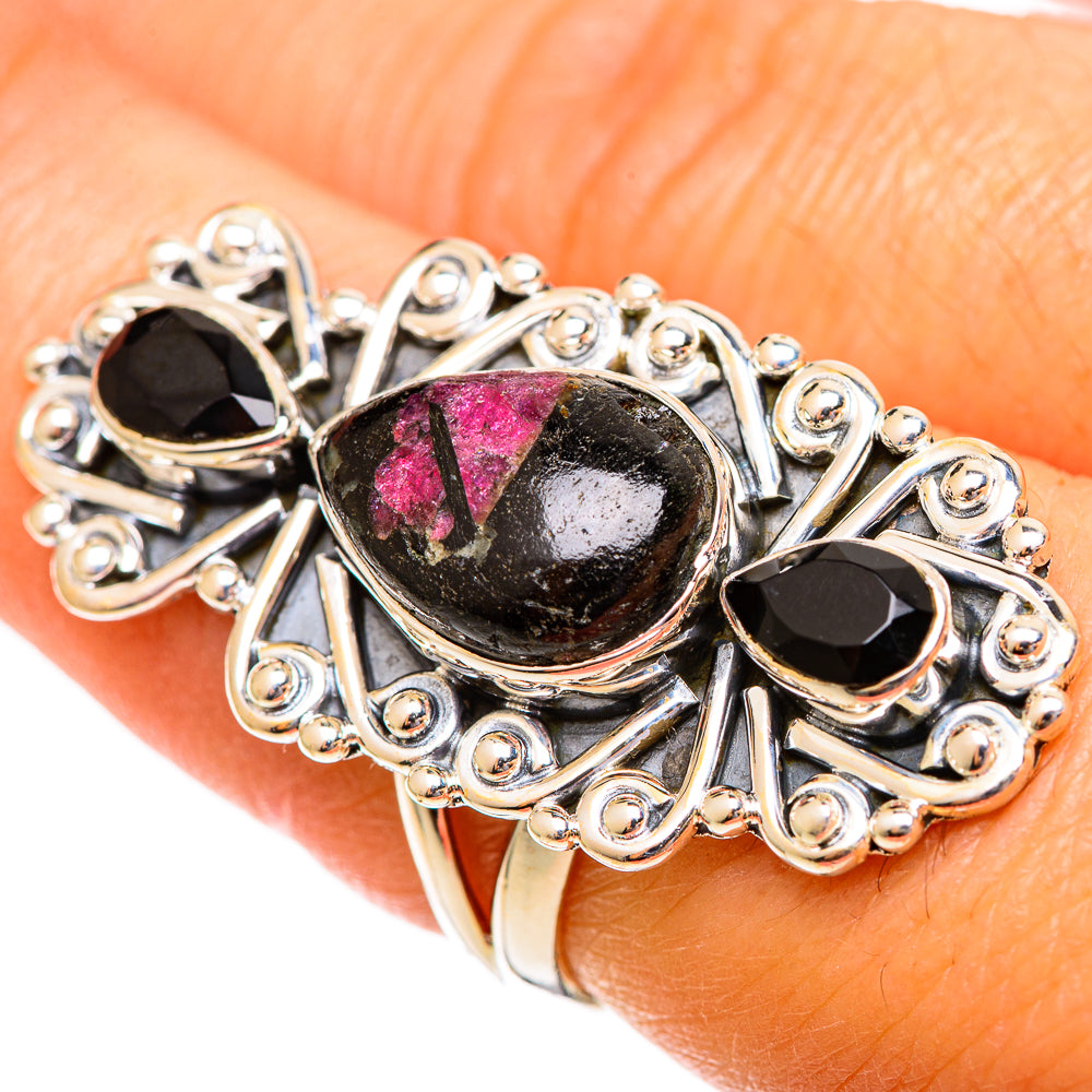 Sterling silver filigree ring with oval black gemstone featuring pink streaks