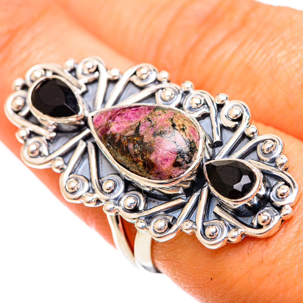 Sterling silver ring close-up with rhodonite oval center and two black onyx accents