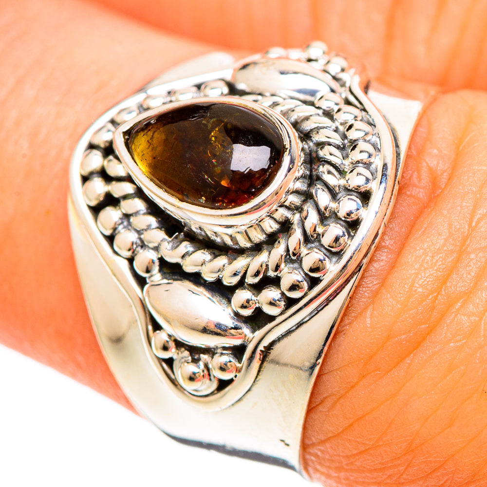 Sterling silver ring with dark oval gemstone and beaded filigree bezel
