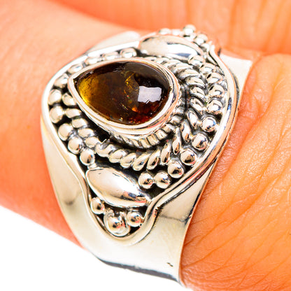 Sterling silver ring with dark oval gemstone and beaded filigree bezel