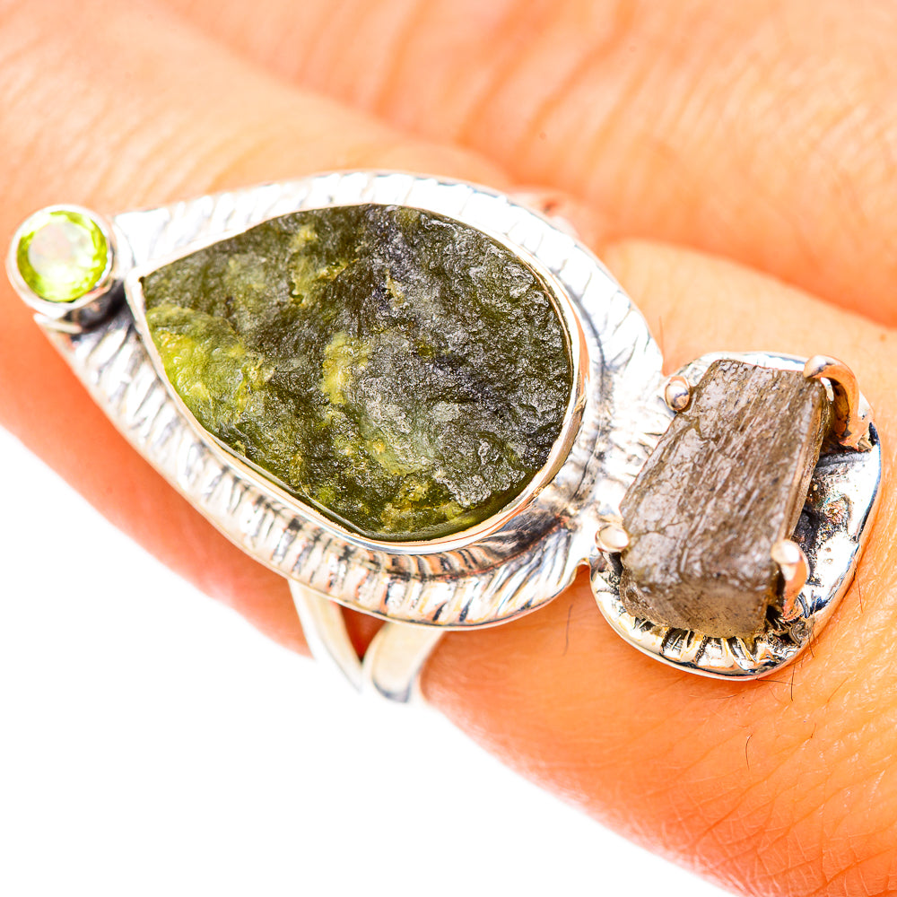 Sterling silver ring with oval green rough stone, round green accent, and rectangular side stone