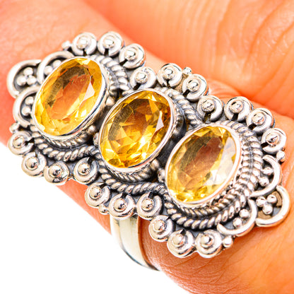Sterling silver citrine ring with three faceted ovals on finger, ornate bead setting