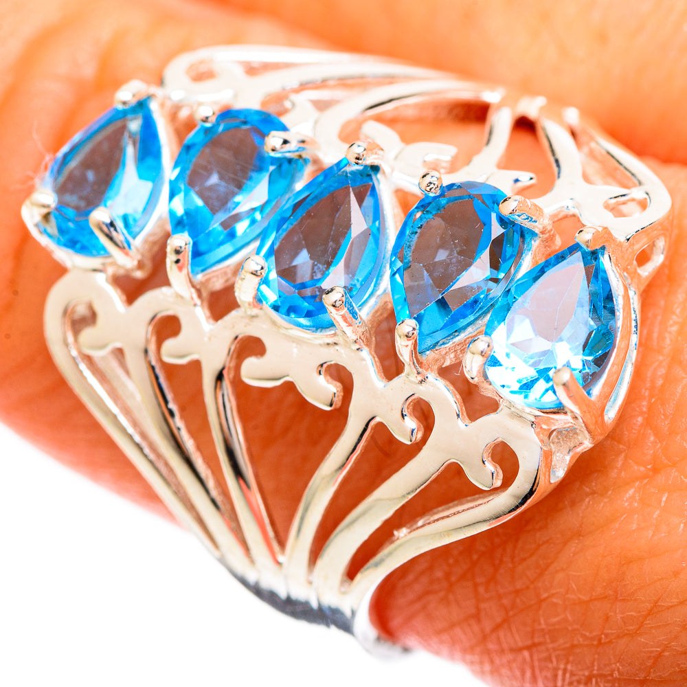 Sterling silver filigree ring with four blue oval gemstones, openwork band
