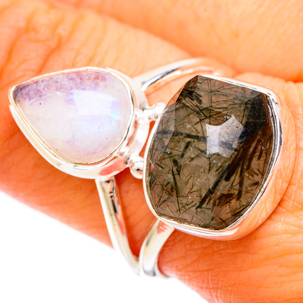 Sterling silver ring close-up with opal-like teardrop and faceted dark green quartz