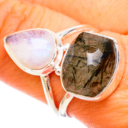 Sterling silver ring close-up with opal-like teardrop and faceted dark green quartz
