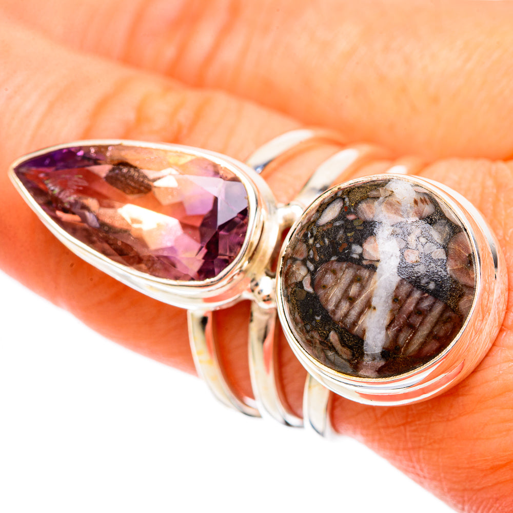 Close-up oval ametrine center stone and round crinoid fossil cabochon on silver ring