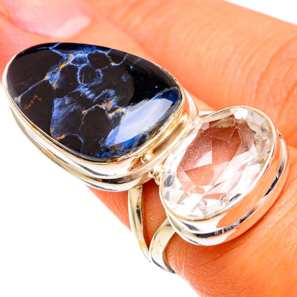 Gold-tone ring with blue pietersite oval center and clear oval quartz bezel