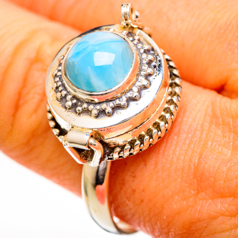 Sterling silver larimar ring with blue oval gemstone and textured halo, side prongs