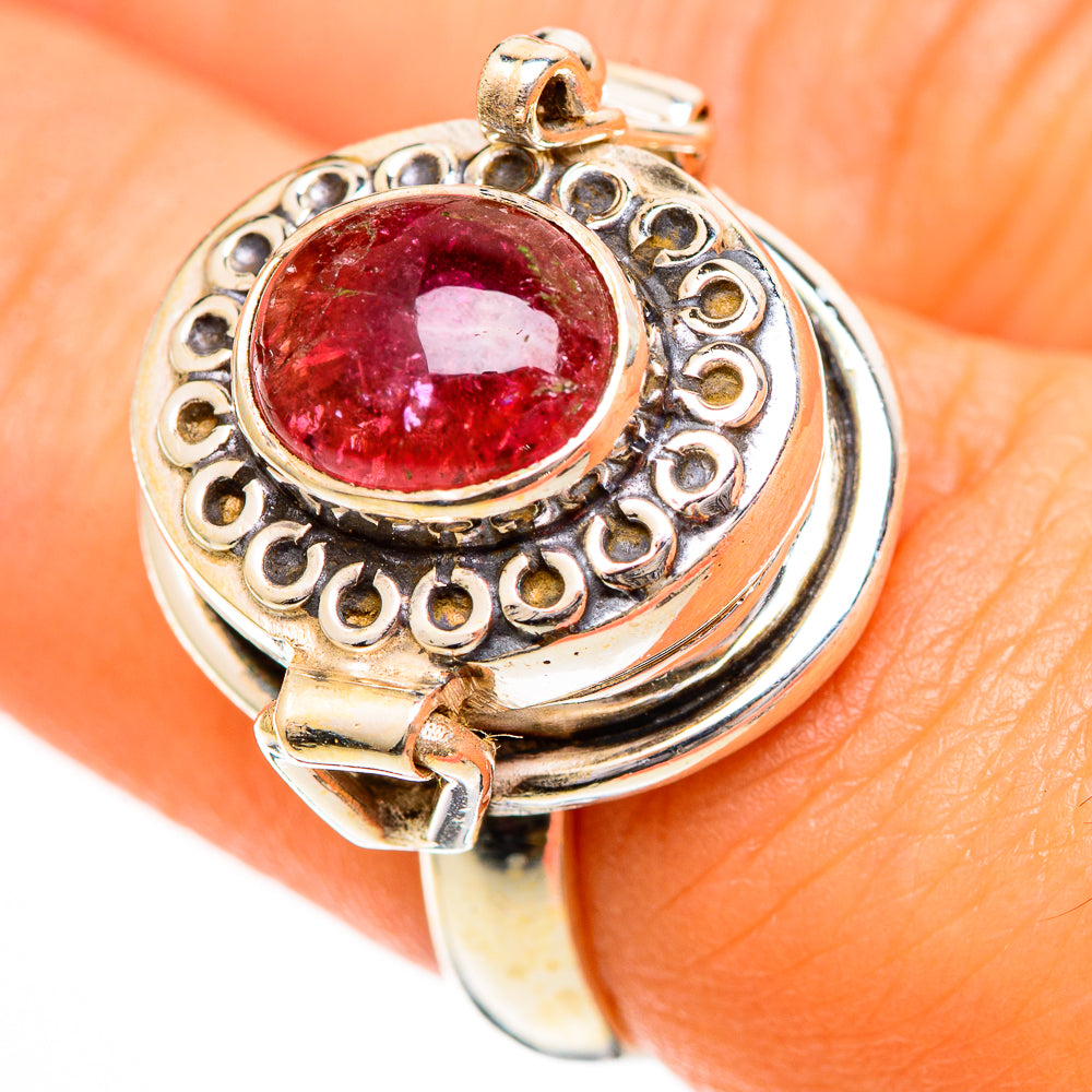 Sterling silver tourmaline ring with round pink-red center stone and detailed filigree setting
