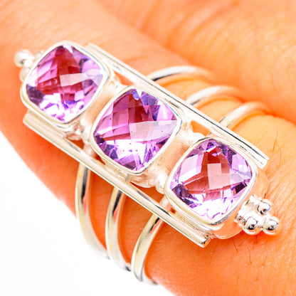 Sterling silver band ring with three faceted pink-purple square stones on top
