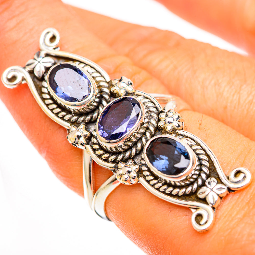 Sterling silver ring with three oval deep blue faceted stones on detailed band