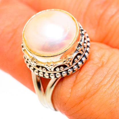Cultured pearl ring with close-up iridescent pearl and detailed silver filigree sides