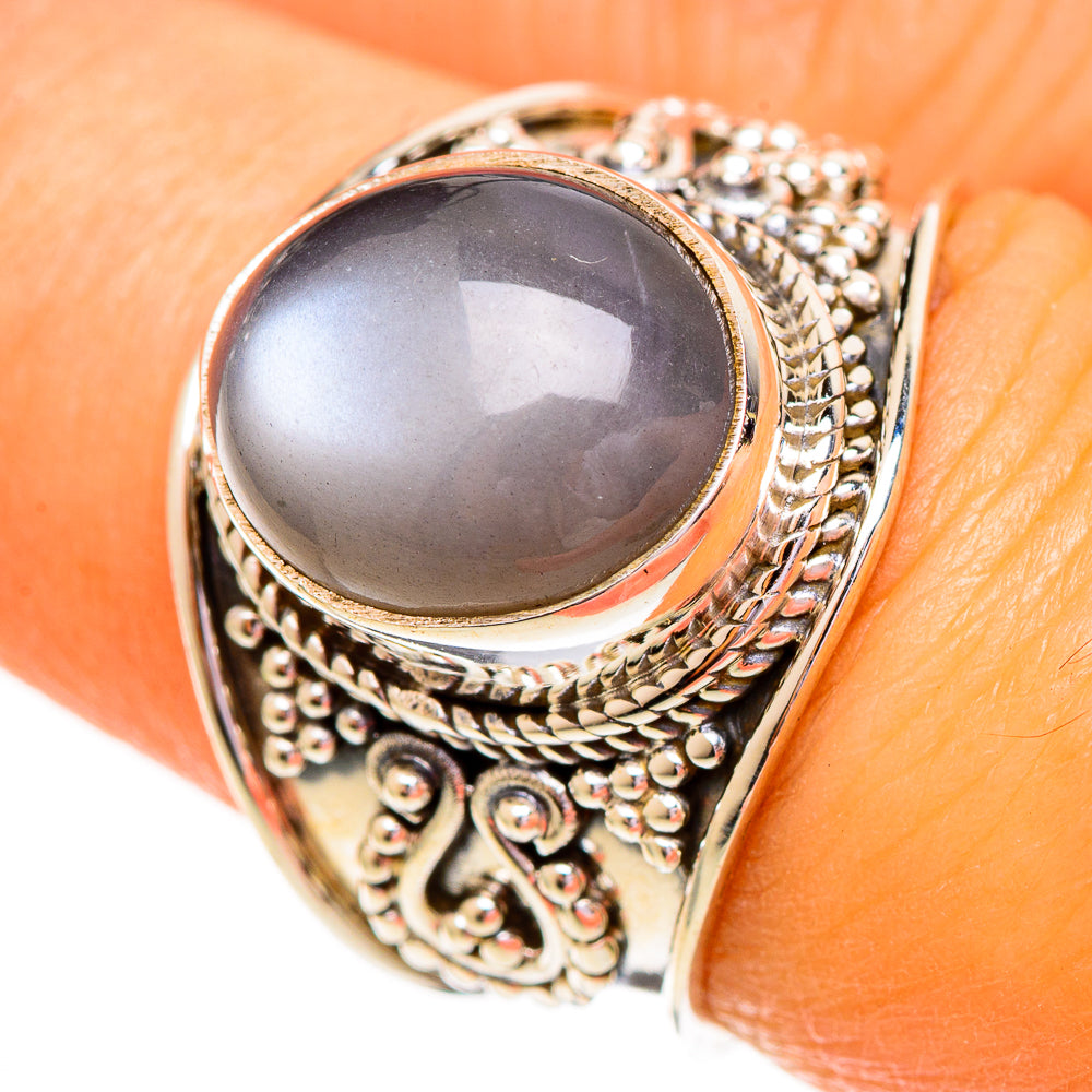 Gold-tone sterling silver oval cabochon ring with ornate filigree bezel