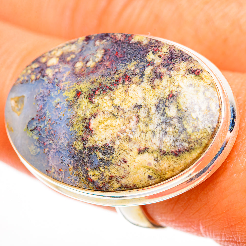 Sterling silver ring with oval plume agate cabochon, speckled yellow, blue, and black