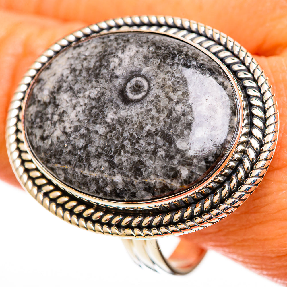 Sterling silver oval fossil ring with dark gray goniatite cabochon and braided bezel