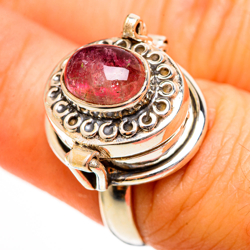 Silver-tone oval gemstone ring with ornate halo setting, pink tourmaline cabochon