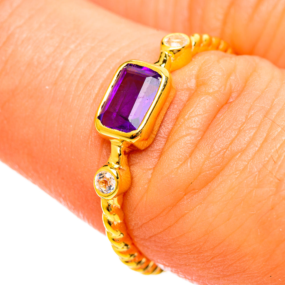Gold-plated faceted amethyst ring with small clear side stones on textured band