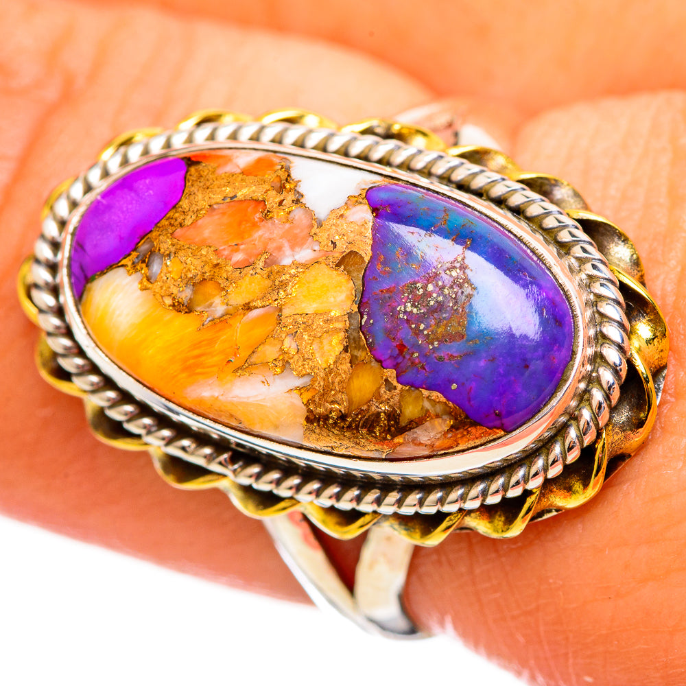 Oval gemstone ring with purple-blue and orange gold matrix, rope bezel on silver band