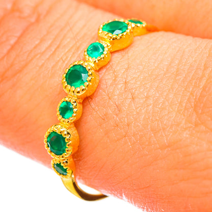 Gold-plated ring bracelet-style view with five green oval stones on skin