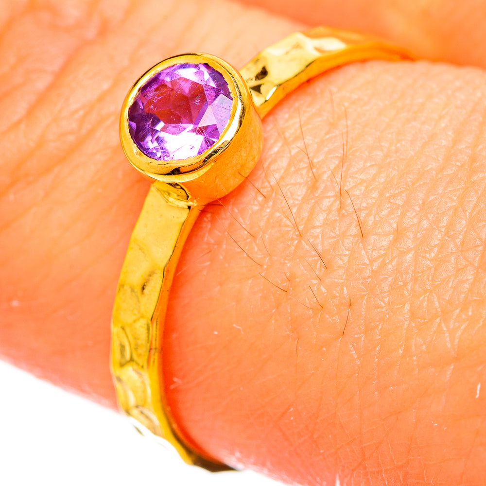 Gold-plated amethyst ring close-up of round faceted purple stone