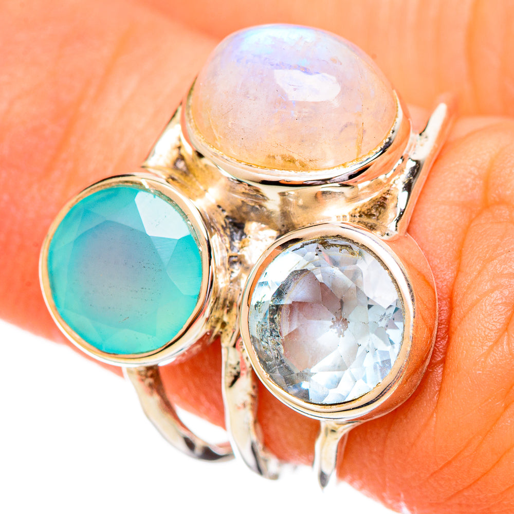 Gold-tone gemstone ring with white round, aqua green round, and clear blue oval stones