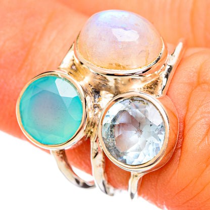 Gold-tone gemstone ring with white round, aqua green round, and clear blue oval stones