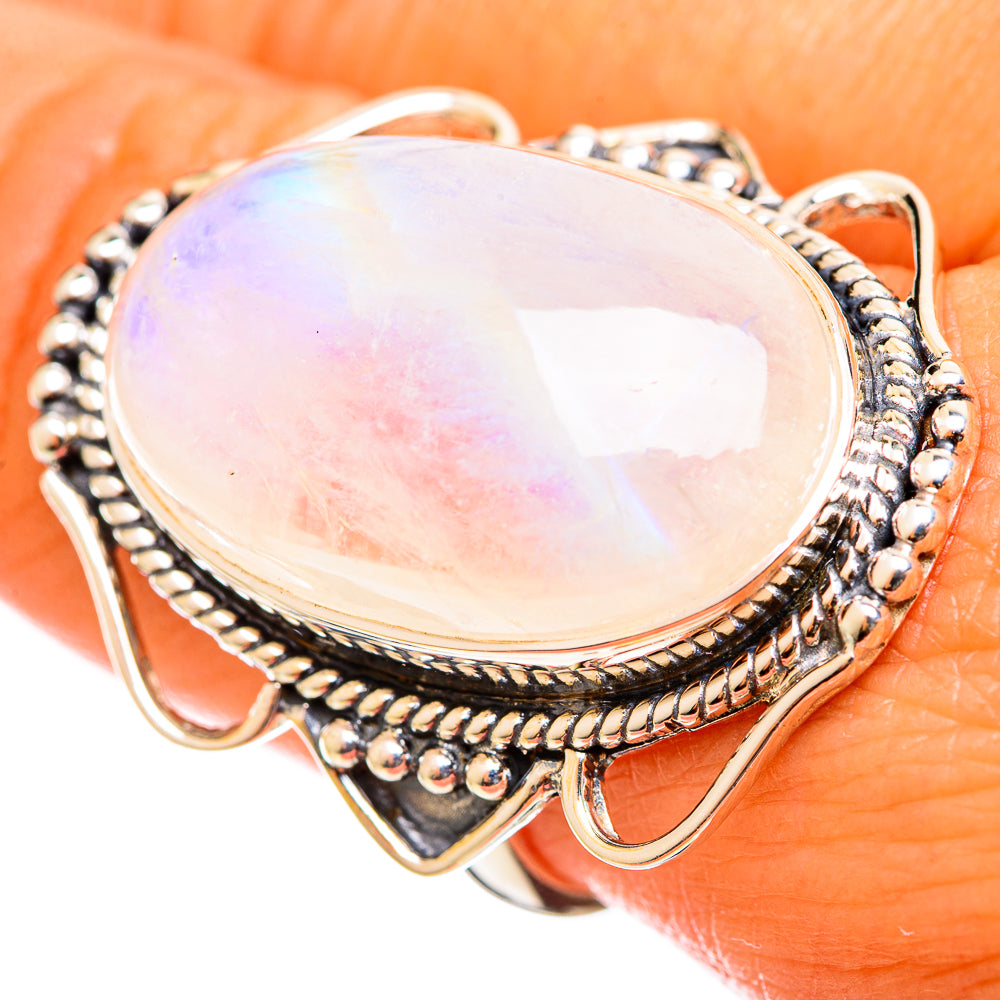 Large oval opalescent moonstone ring with textured silver border and openwork sides