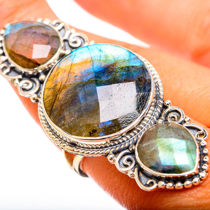 Three-stone labradorite ring with oval settings; bright blue and gold iridescence on silver