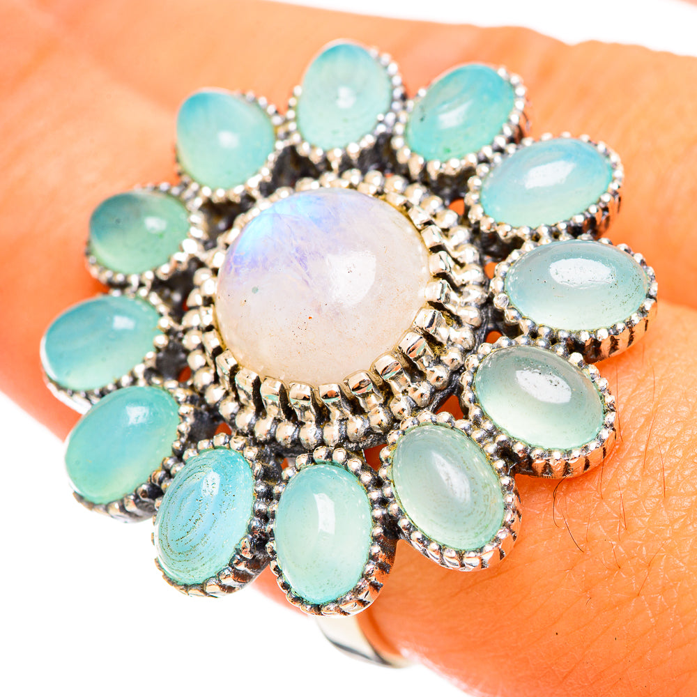 925 sterling silver cluster ring on finger, round moonstone center with oval aqua stones