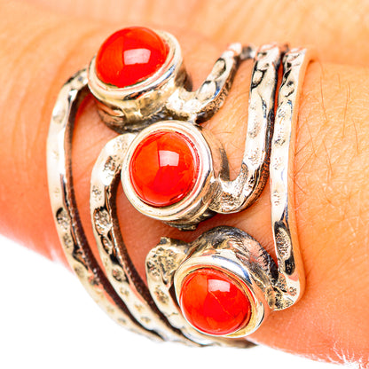 Sterling silver ring with three round red coral cabochon stones, close-up