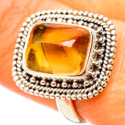 Citrine sugarloaf ring in sterling silver, oval bezel with glowing yellow gemstone