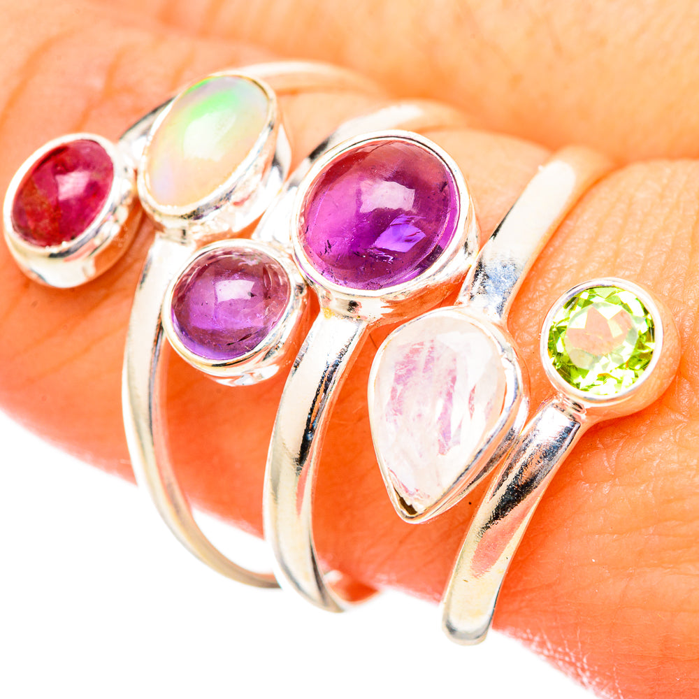 Sterling silver ring with oval and round gemstones: purple, red, green, and opal.