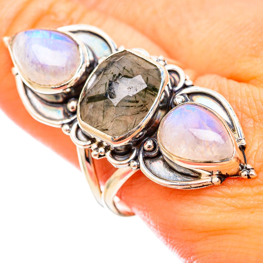 Sterling silver ring with three prong-set stones: two pale opal ovals and dark green center