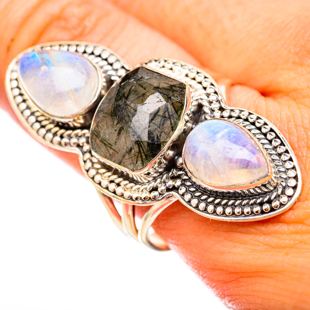 Sterling silver ring with two oval opal cabochons and a central dark green quartz stone