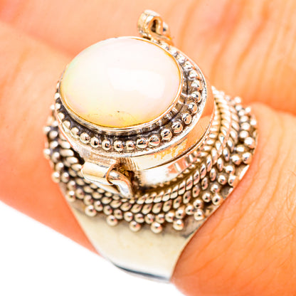 Sterling silver opal ring with oval white opal cabochon and beaded halo setting